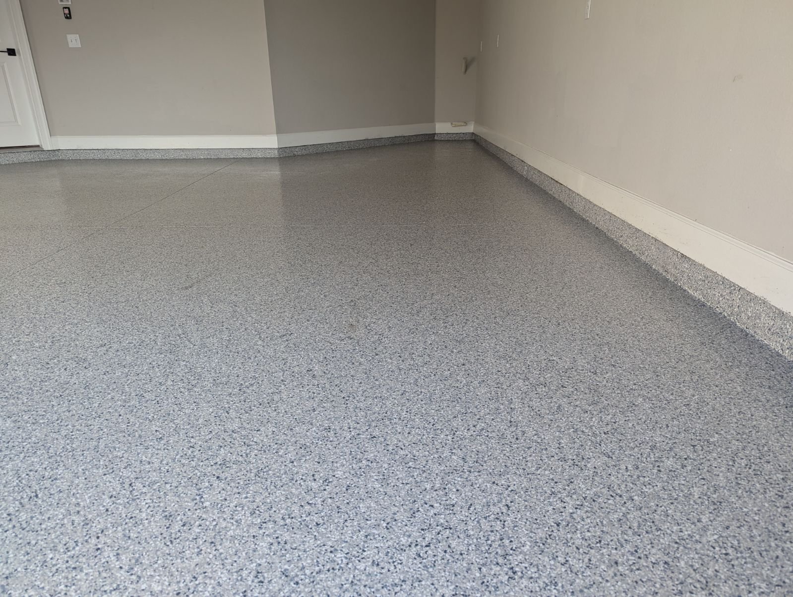 Clean blue-grey flake garage interior with dramatic side lighting