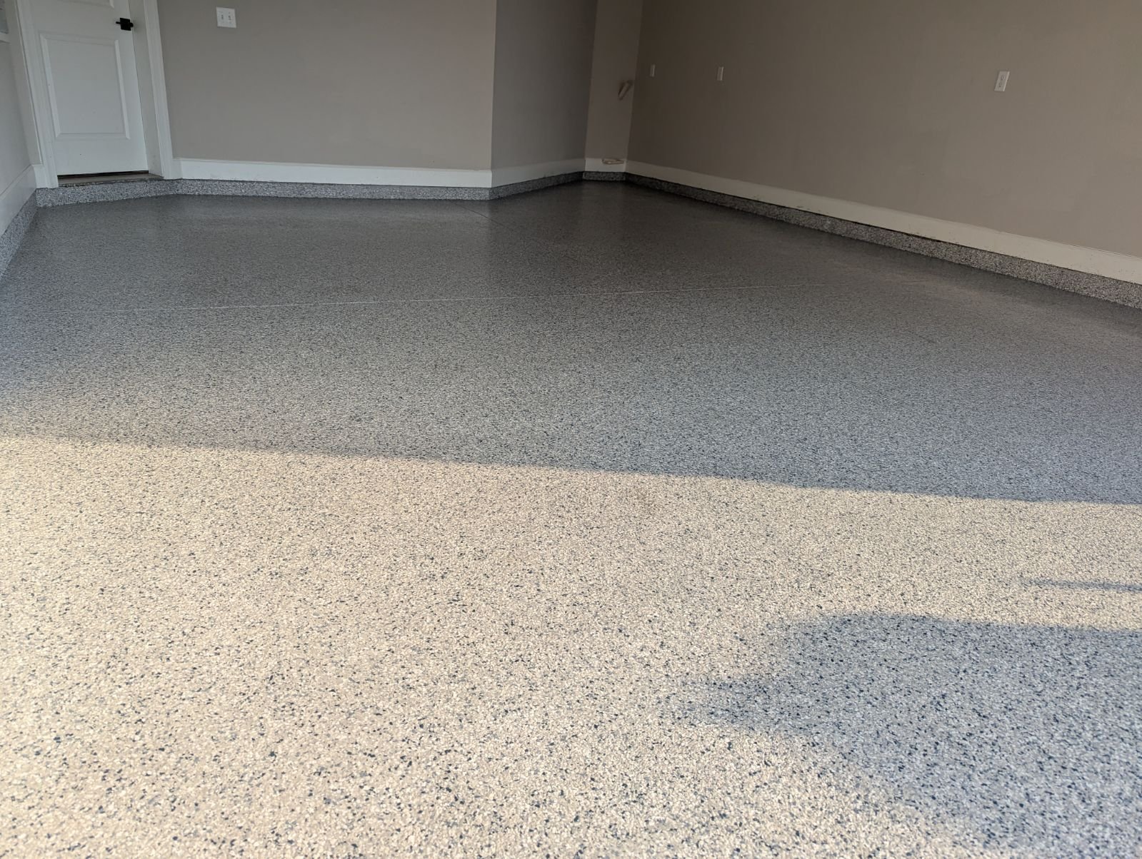 Wide finished grey-and-cream flake garage floor