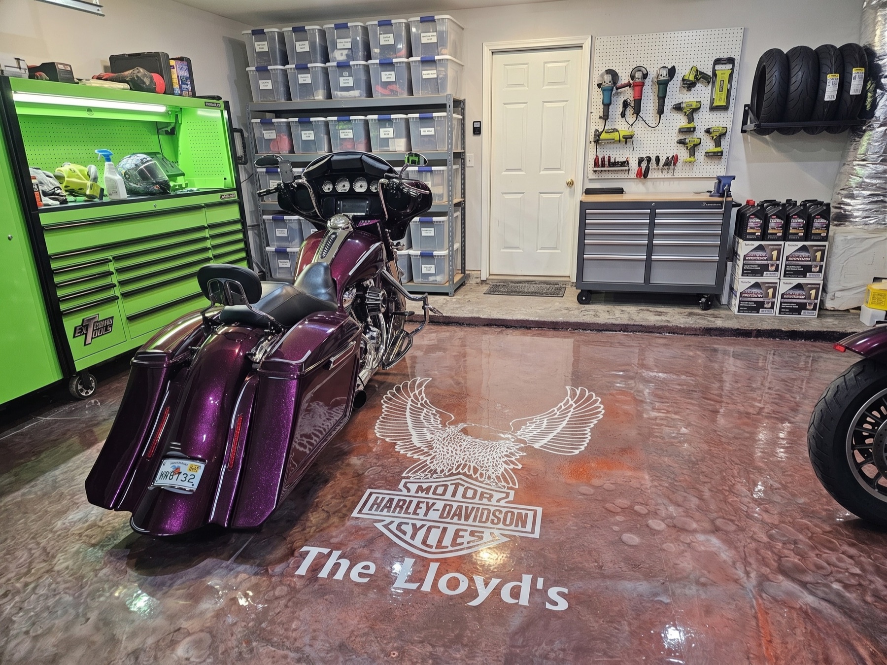 Custom copper-metallic garage floor with parked Harley-Davidson and 'The Lloyd's' stencil, Northeast Florida